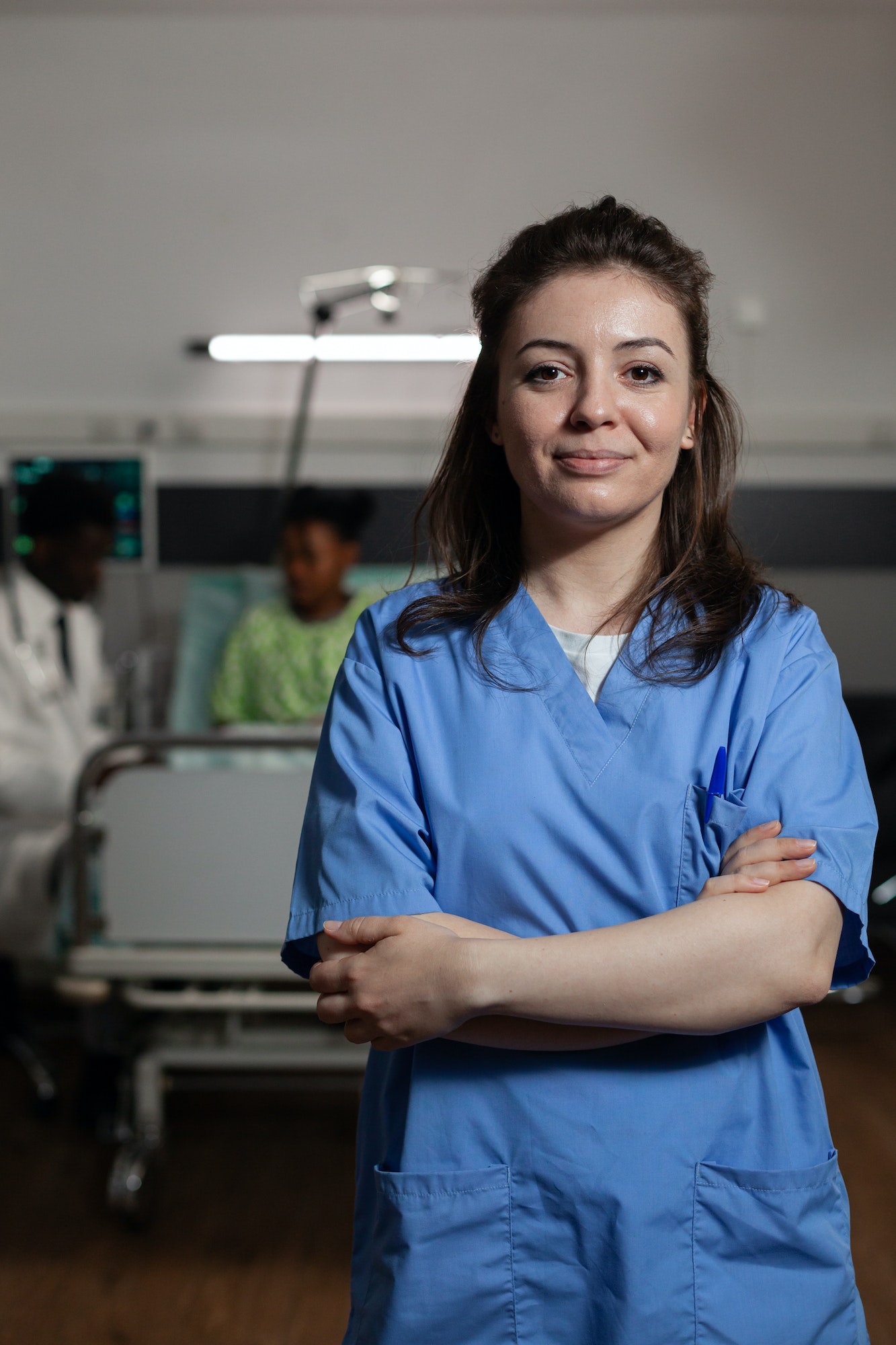 Portrait of specialist therapist nurse standing in hospital ward